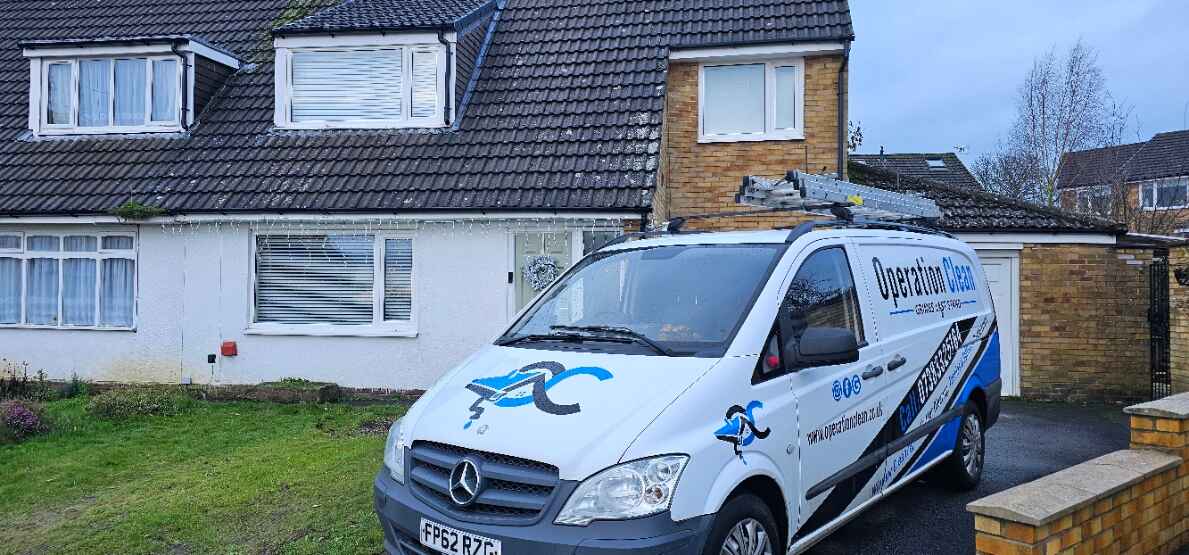 Operation Clean team member using gutter vac on a residential property